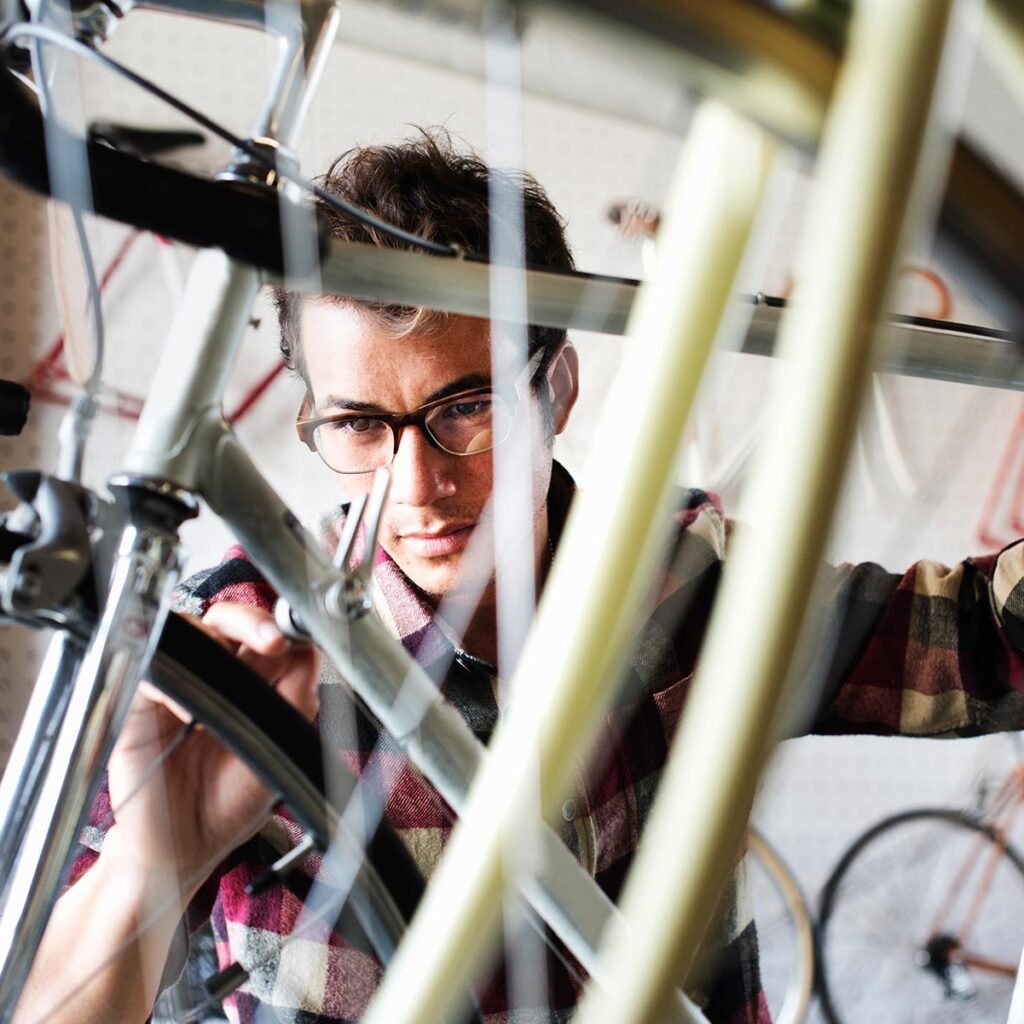 a man working in a bicycle repair shop 3ud87kk.jpg
