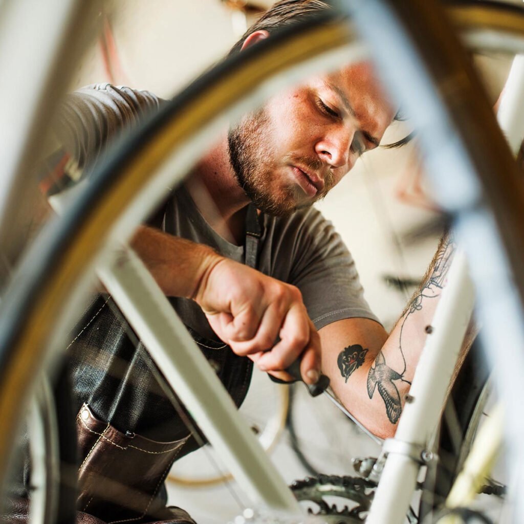 a man working in a bicycle repair shop afe8hst 1.jpg