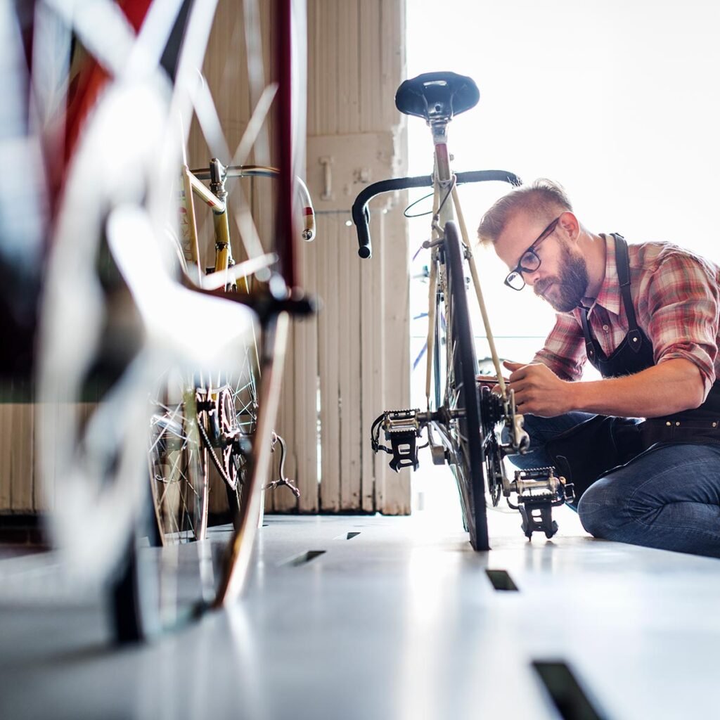 a man working in a bicycle repair shop m3ybhtf.jpg