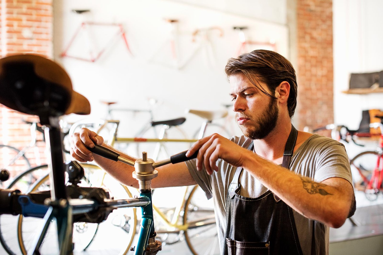 a man working in a bicycle repair shop checking th 9frj9wl.jpg